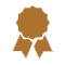 A brown ribbon award icon with a circular center and two ribbons hanging down.