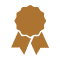 An icon of a brown ribbon-shaped badge with a scalloped edge, resembling an award or medal, reminiscent of the earthy tones found in outdoor furniture.