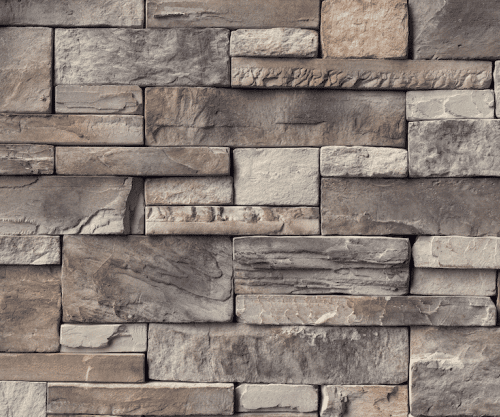 A close-up view of a wall made of rectangular, grey-toned stone bricks arranged in a stacked pattern.