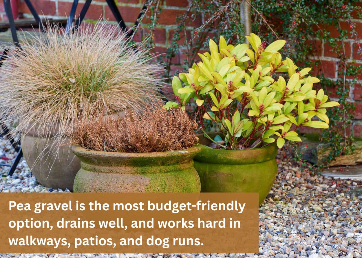 Decorative landscape planters surrounded by pea gravel with ornamental grasses and colorful shrubs.